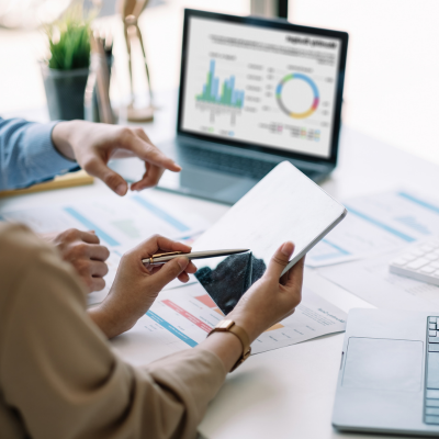 Certified business and finance consultants discussing financial planning in Lahore office